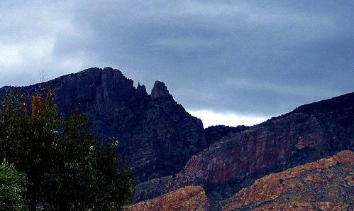 This is the view of the Catalina Mountains from my third-floor bedroom balcony. The sliver of rock between the two larger humps is called finger rock. I've adopted it as a finger pointing at me, asking: "So have you met your writing goal today."  -- Photo by Pat Bean 